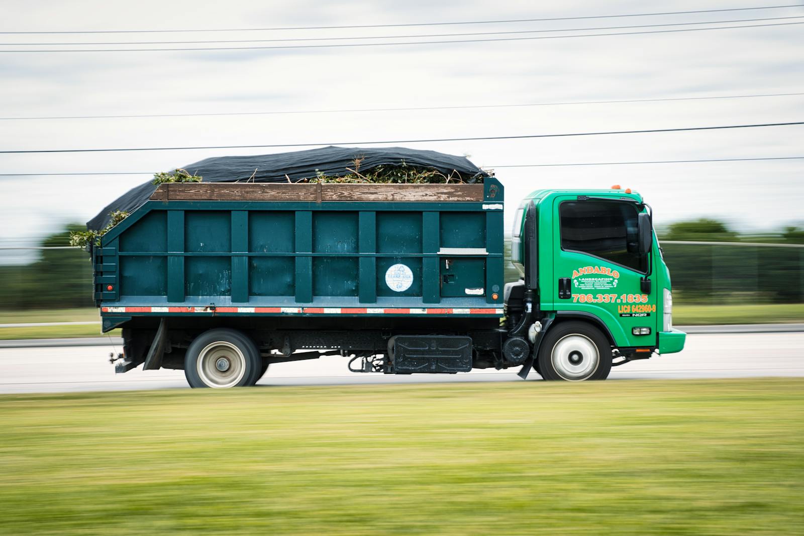 Pickup loaded with bagged palm fronds and yard waste headed to the transfer station.
